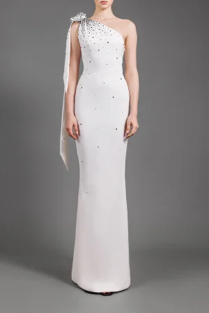 ONE-SHOULDER WHITE CRÊPE DRESS EMBROIDERED WITH BLACK CRYSTALS AND BOW DETAIL