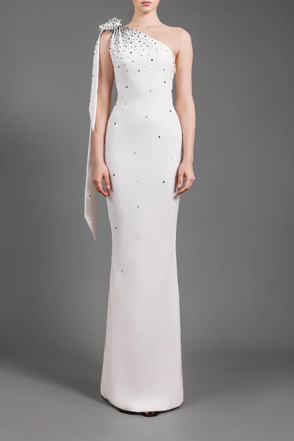 ONE-SHOULDER WHITE CRÊPE DRESS EMBROIDERED WITH BLACK CRYSTALS AND BOW DETAIL