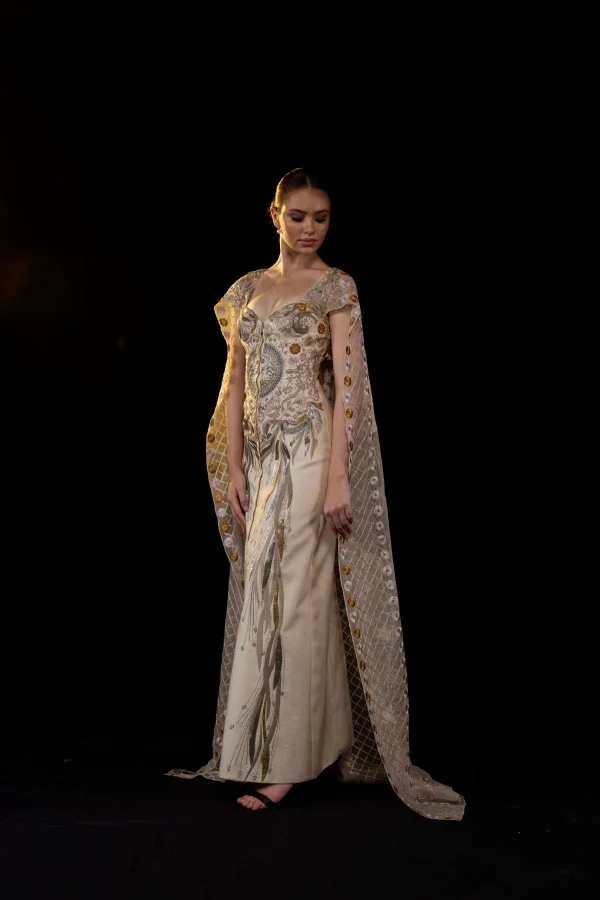 A SHEER NECK, FLOOR-LENGHT EMBROIDERED GOWN CAPE DRAPES FROM THE SHOULDERS - Image 4